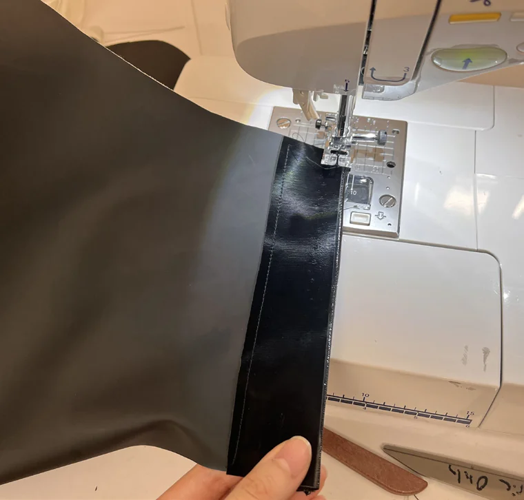 The garment being assembled at a sewing machine.